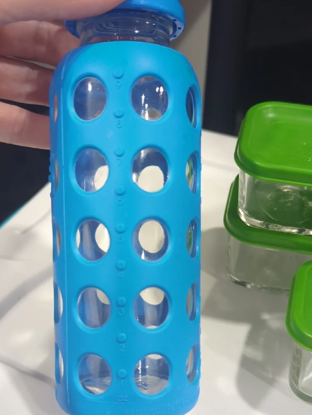 Glass Food Storage Set with Green Lids and Assorted Silicone Bottles